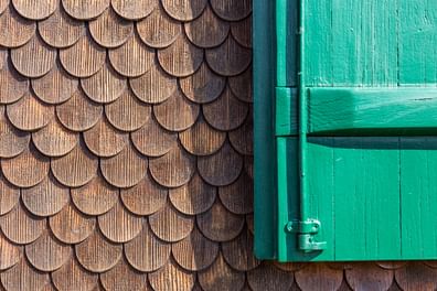 Holzfassade mit grünem Fensterläden