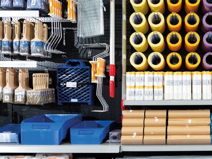 Gut organisierte Werkstatt- oder Lagerwand mit verschiedenen Maler- und Handwerksutensilien
