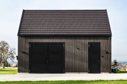 Seitenansicht des Wohnhauses mit Holfassade und Satteldach