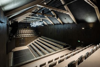 Auditorium von oben mit Spitzdach und Deckenlichtern