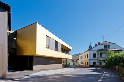 Modernes Gebäude der Bäckerei Reisinger in Gutau mit großzügigen Glasfronten und einer Fassadengestaltung mit CapaGold.