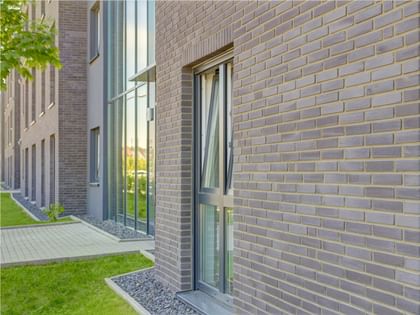 Helle Fassaden mit feinem Steindetail – klar, freundlich und modern inszeniert