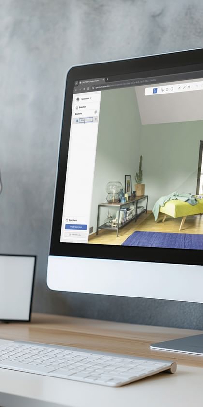 iMac auf Schreibtisch zeigt Raum mit Bett und Wandgestaltung in Spectrum