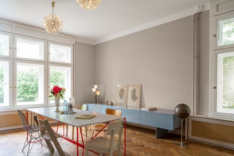 Esszimmer mit Tisch, sechs Stühlen und blauem Sideboard