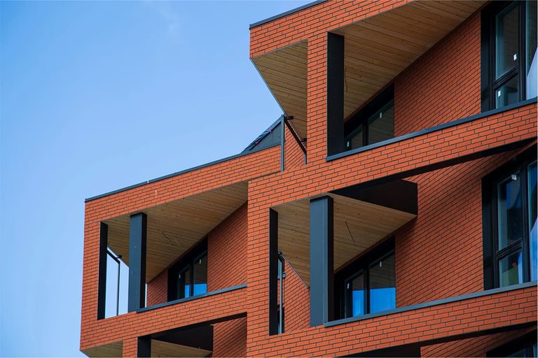 Geometrische Fassaden mit tiefroten Verblendern – mutig, urban und ausdrucksstark
